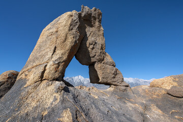 Boot Arch in Alabama Hills: A Unique Formation Against Snowy Peaks