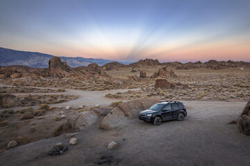 Rocks and a Camper Car Illuminated by Sunset Light