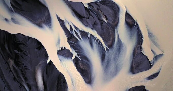 An aerial journey over Skei&eth;ar&aacute;rsandur captures a stunning network of glacial meltwater streams flowing across vast volcanic plains, forming intricate patterns that resemble living veins icelandic