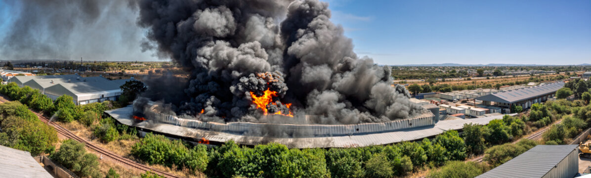 Fototapeta Major Industrial Blaze, Huge Factory Fire Incident Highlighting Severe Insurance Risk and Property Destruction,