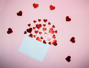 Envelope with red hearts on pink background. Valentine's day concept.