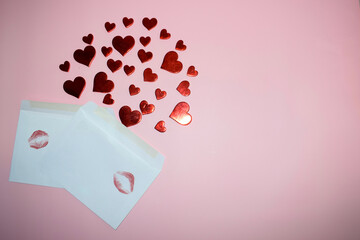 Envelope with red hearts on pink background. Valentine's day concept.