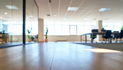 Modern office interior with hardwood floor sunlight and blurred workstation in background creating calm professional atmosphere