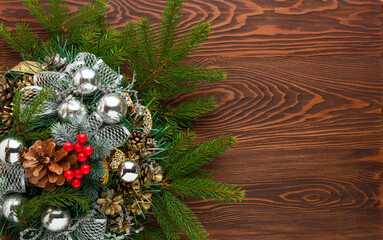 Fresh fir branches and large pine cones on a dark wooden background