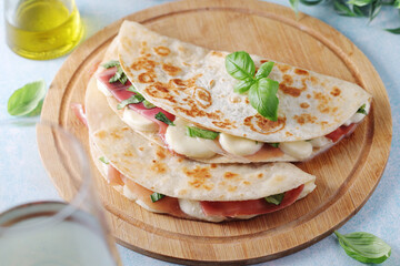 Traditional Italian dish Piadina romagnola - flat bread with mozarella and proscuitto