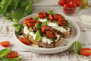 Italian sandwiches with grilled tomatoes, burrata cheese and pesto