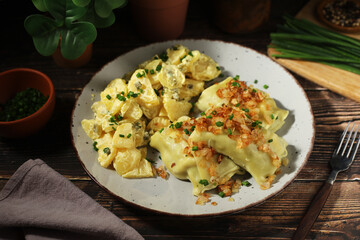 Traditional Swabian dish Maultaschen served with roasted onion and potato salad	