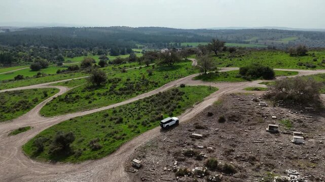 Aerial 4K footage of Ben Shemen Forest in central Israel, featuring the iconic &ldquo;Chinese House&rdquo; structure surrounded by dense Mediterranean woodland. The drone captures sweeping views of green pine tre