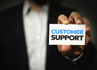 Customer Support card shown by a person towards camera close up concept backdrop