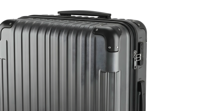 Close-up of a silver, ribbed, rectangular suitcase with black corner protectors