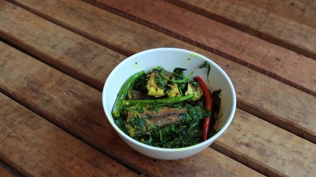 Prepared curry of fish and spinach.