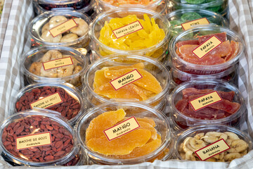 Fototapeta premium Assortment of packaged dried fruits, including mango, papaya, banana, figs and goji berries, at a local market in Italy
