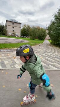 A child boy is roller skating