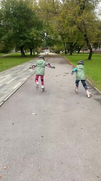 A boy and a girl are roller skating