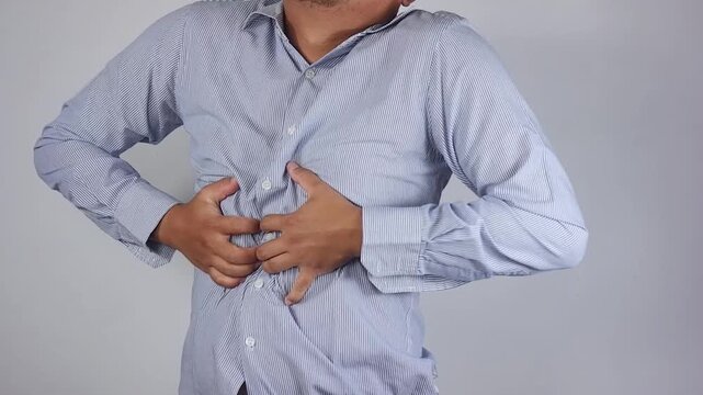 Chest pain. A man's hand is holding his chest. A man in pain is massaging the affected area. Heart attack, myocardial infarction or ischemia, myocarditis, pneumonia, shortness of breath. Emergency
