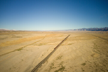 Railroad boxcars on a siding in a stretch of desert in utah