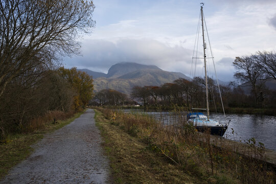 Sailing boat moored at a jetty on the towpath of the Caledonian Canal with views of Ben Nevis. Corpach, Lochaber, Scottish Highlands.
