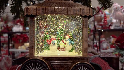 A charming vintage wooden train case hosts a glittering snow globe scene with cheerful snowmen. - Powered by Adobe