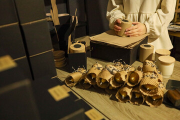 Artisan crafting candles with natural materials in a cozy workshop setting