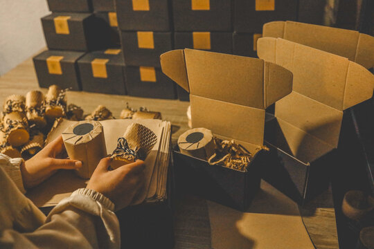 Artisan packaging of handmade candles in eco-friendly cardboard boxes