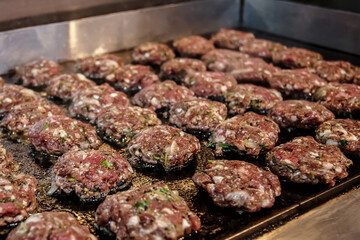 Grilling beef patties on a hot grill