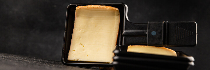 Raclette cheese portion slicing natural product tasty snack fresh delicious gourmet food background on the table rustic top view copy space