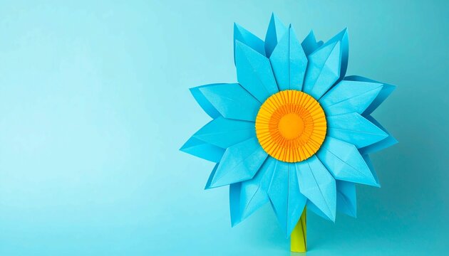 Bright blue and yellow origami flower with geometric folds, beautiful paper craft design, creative handmade decoration on a vibrant light blue background, art and hobby concept, space for text