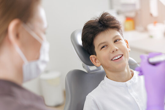 Portrait happy young caucasian male child smiling at pediatric dentist office for dental checkup