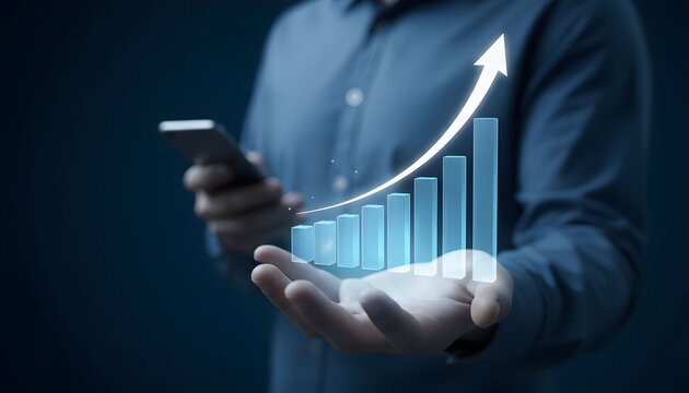 Businessman holding a smartphone and a glowing digital graph indicating business growth and success.