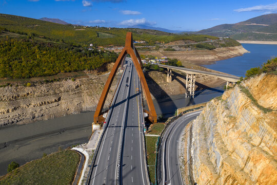 Aerial view of the A1 motorway crossing the Drin Valley near Kuk&euml;s, featuring the new Kuk&euml;s Bridge and surrounding autumn landscapes.