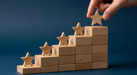 Hand placing the fifth star on a wooden block staircase representing top rating and customer satisfaction

