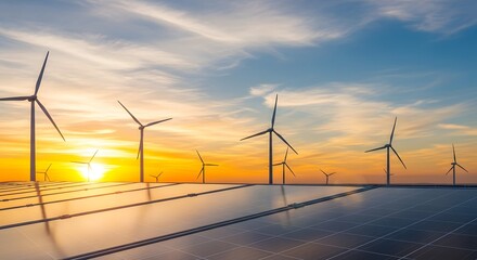 Fototapeta premium Wind turbines and solar panels at sunset sustainable energy future
