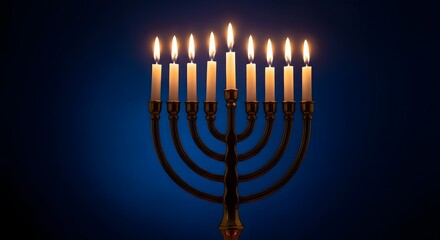 A traditional Hanukkah menorah with nine lit candles glowing warmly against a dark blue background.