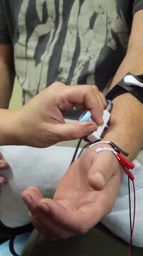 Electromyography. A man undergoes an examination on an electromyograph. A new field in medicine is electroneuromyography - vertical video