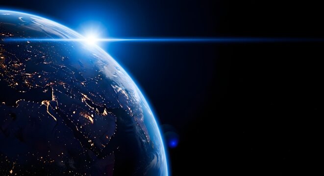 Sunrise over earth viewed from space showing city lights at night