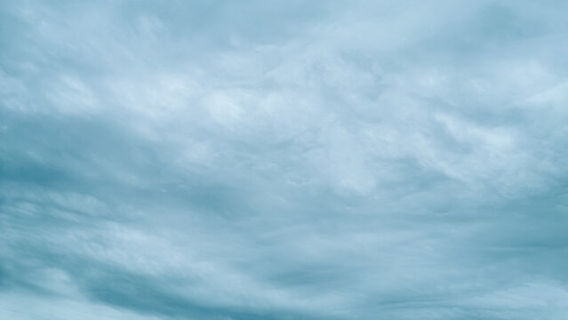 Overcast sky background with dramatic gray and white storm clouds. - Powered by Adobe