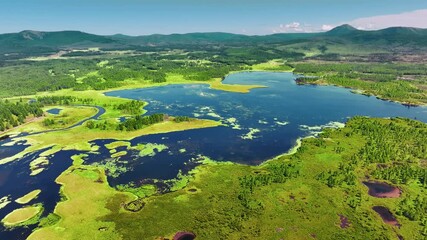 Aerial panoramic view of Aershan lake with azalea blooms in Inner Mongolia wilderness landscape