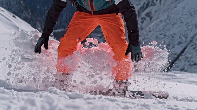Closeup of Snowboarder Jumping with His Snowboard. Super Slow Motion Footage, Filmed on High Speed Cinema Camera, 1000 fps.