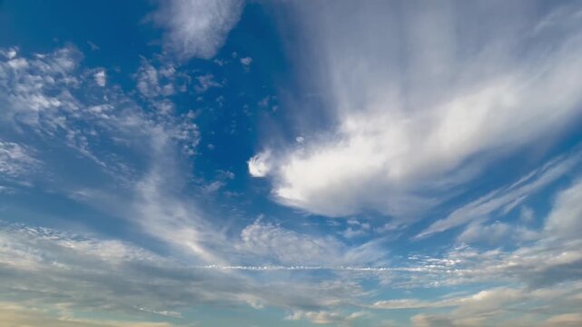 Beautiful timelapse of flowing clouds in a twilight sky, transitioning from blue to a stunning sunset gradient.