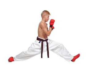 A karate boy in white pants and red gloves does the splits.