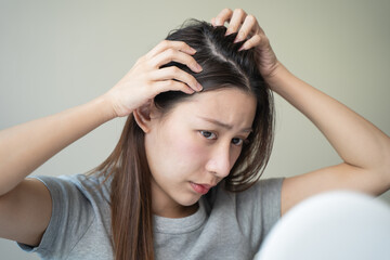Naklejka premium Young woman worrying about her thin hair and hair fall