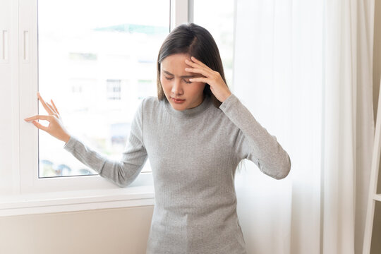 Young Asian females feeling dizzy after standing too fast, have symptoms of low blood pressure