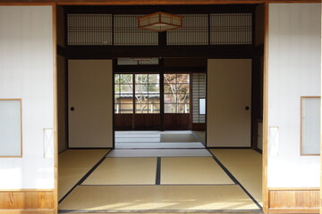 Fototapeta premium Traditional Japanese Tatami Room Interior with Sliding Fusuma Doors and Wooden Architecture