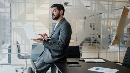 Man working on laptop in modern office space