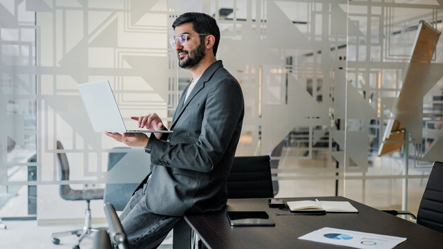 Man working on laptop in modern office space