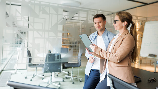 Colleagues discussing ideas in modern office setting