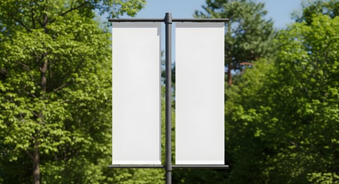 Two blank vertical banners on a pole surrounded by green trees