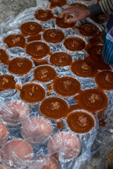 Rural Tradition: Jaggery Molds Covered in Plastic and Ready for Solidification