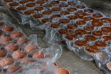Rural Tradition: Jaggery Molds Covered in Plastic and Ready for Solidification