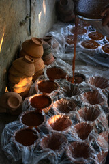 Close-Up of Multiple Jaggery Molds with a Shaft of Light